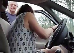 Crossdresser giving handjob in car
